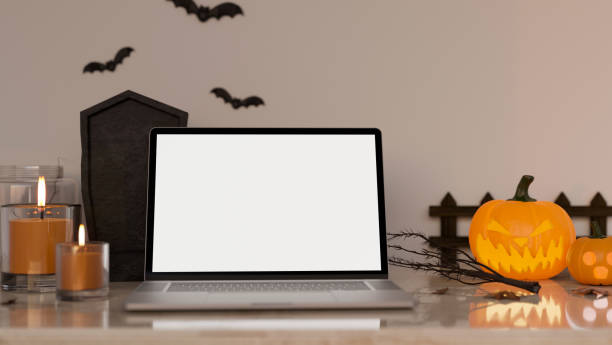 istock Workspace in Halloween theme with notebook laptop white screen mockup and Halloween decor 1417838851