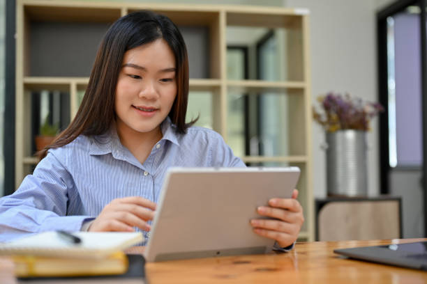istock Asian female business officer worker at her office desk, using digital tablet 1417839749