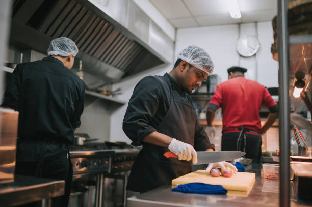 istock Asian Kitchen crew busy preparing food in commercial kitchen 1417839998