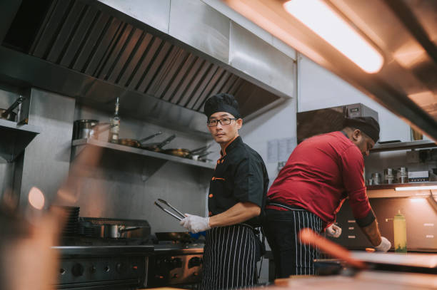 istock Asian Chinese chef looking at camera at commercial Kitchen  preparing food cooking 1417840001