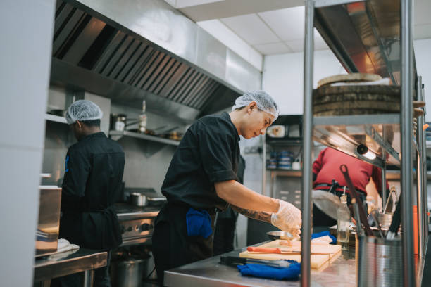 istock Asian Kitchen crew busy preparing food in commercial kitchen 1417840025
