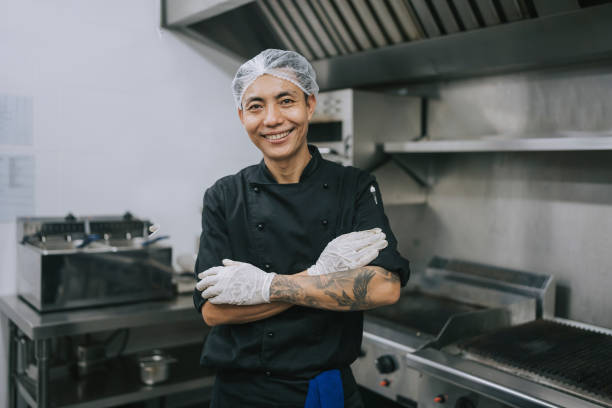 istock Asian Kitchen male crew helper looking at camera smiling 1417840026