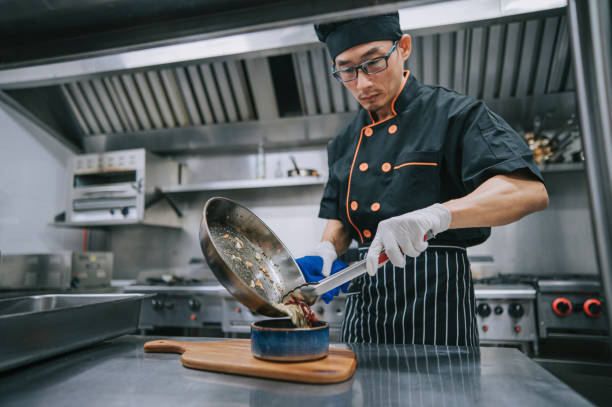 istock Asian Chinese Chef placing cooked meal on display bowl before serving to customer 1417840034
