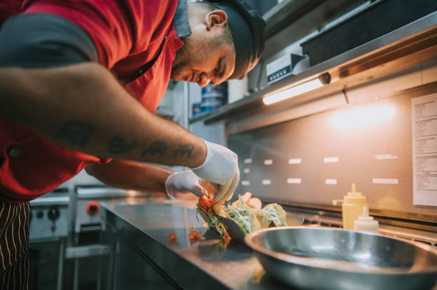 istock Asian Indian Chef preparing taco Mexican food in kitchen 1417840554
