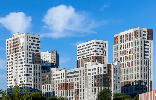 Monolithic residential block apartment buildings district on blue sky