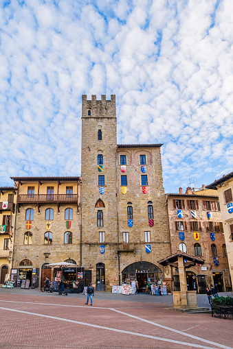 Piazza Grande in Arezzo, one of the most beautiful Italian squares, is surrounded by several historic buildings. People.