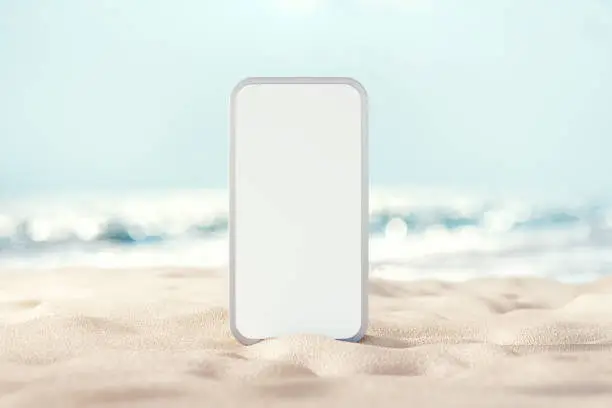 Background blank mobile phone on sand beach, Space for promotion of summer.
