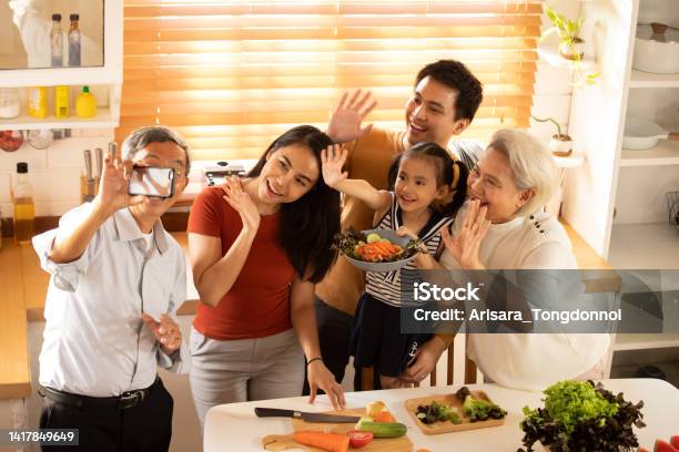 A Large Family Is Taking Selfies In The Kitchen Stock Photo - Download Image Now - 25-29 Years, 30-34 Years, 4-5 Years
