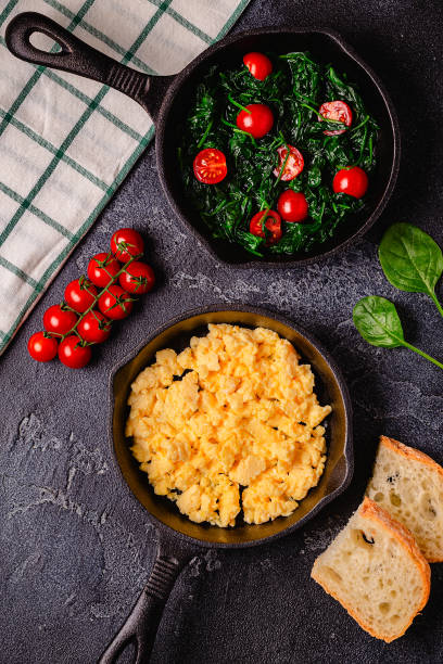 istock Cooked omelet and spinach with tomatoes in pans 1417850919
