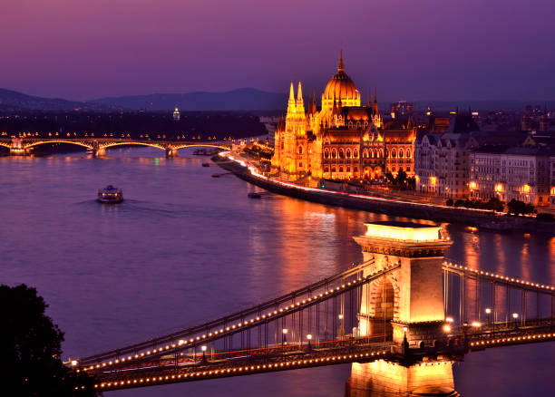 Hungarian Parliament Building, Budapest Spanning the Danube River in foreground is the town's oldest, the Széchenyi Chain Bridge. danube river stock pictures, royalty-free photos & images