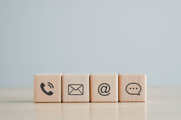 istock Website page contact us or e-mail marketing concept, Customer support hotline Contact us people connection. phone, email, address and chat message icon on wooden blocks 1417854215