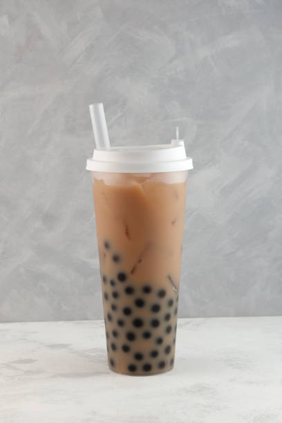 istock Bubble milk tea, tapioca milk tea, or boba drink. Disposable plastic cup. Take away street fast food. 1417859224