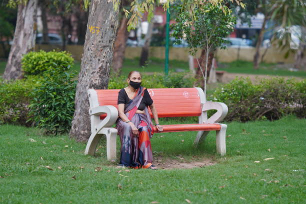 Rajasthan, jaipur, India- 15 ‎august ‎2022 :old women sitting in park hd.
