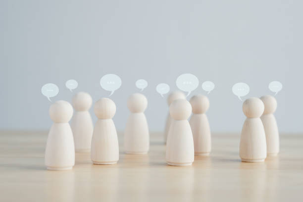 istock Team discussion, Community or social feedback. Communication or announcement dialog. Business meeting. Teamwork and communication concept. Many wooden figure with speech bubble. 1417859592