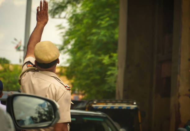 Rajasthan, jaipur, India- 15 ‎august ‎2022 :Policeman raising his hand to stop the vehicle