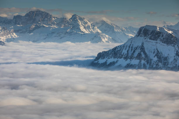 istock Splendid apline scenery. High mountains with fog and lovely evening light. 1417864475