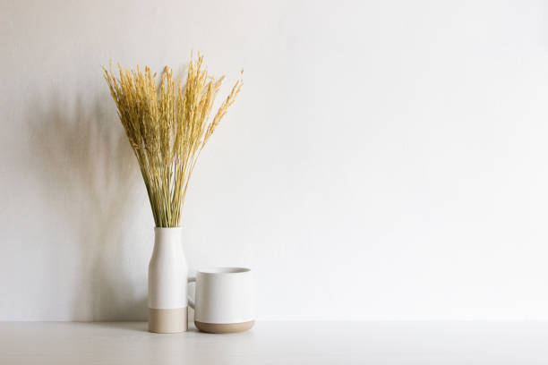 istock White flowers and coffee cup over the table with natural light. 1417865195