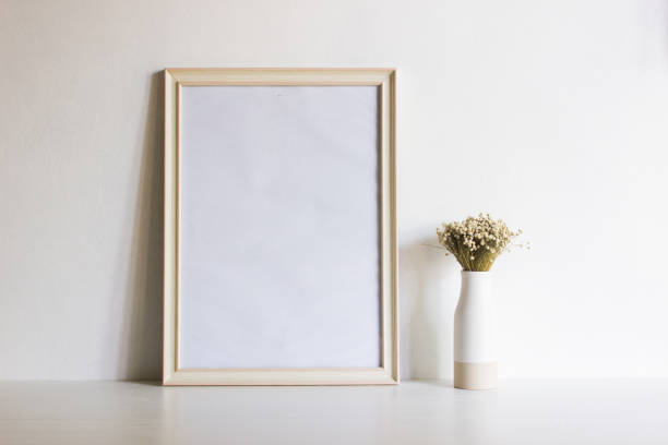 istock White flowers with white frame over the table with natural light. 1417865204