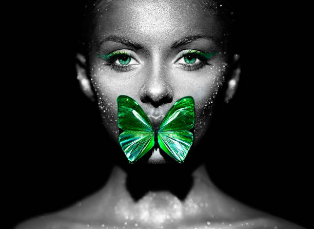 istock Beauty model woman with green butterfly 1417865897