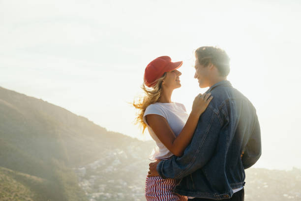 istock Romantic couple looking at each other on mountain at sunset 1417867349
