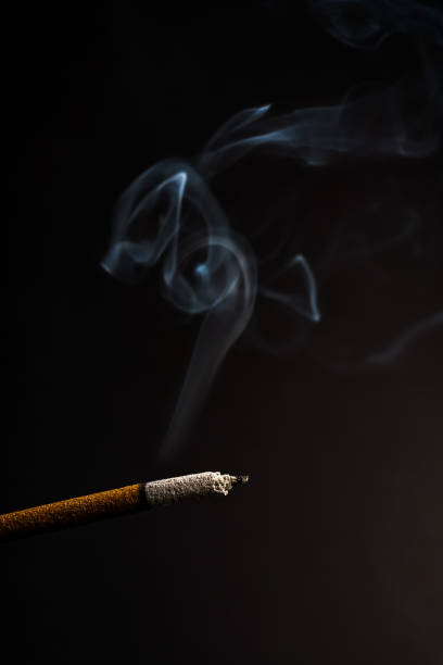 istock burning incense rising in smoke on a black background 1417867531