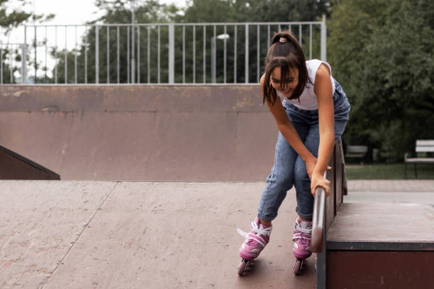 Portrait of a girl learning to inline skates. stock photo