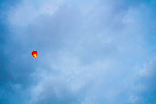 A red sky lantern in a gloomy blue sky
