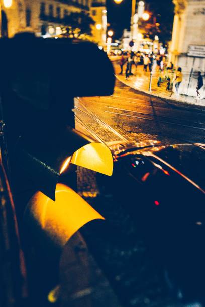 istock Vertical shot of a yellow traffic light at night 1417869864