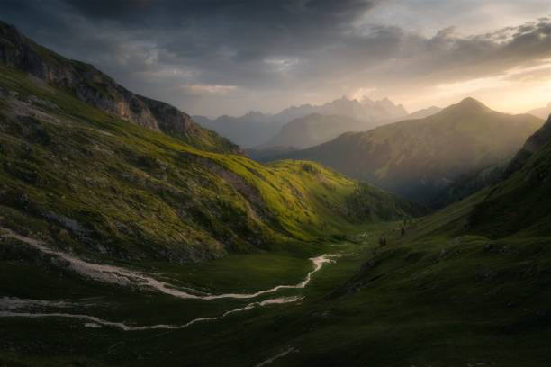 istock River passing through the green fields with rocky mountains in the background 1417870148