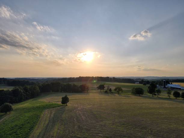 istock Shot of a sunrise with fields and trees in a town 1417875586