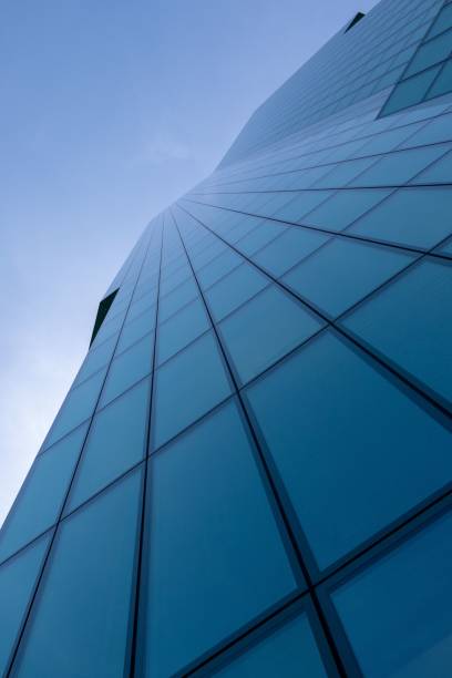 istock Vertical under the view of a modern blue skyscraper with sky in the background 1417875594