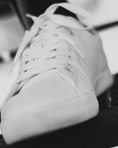 istock Closeup grayscale shot of a stylish white sneaker 1417876876