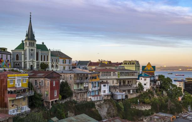 Picturesque Chilean town of Valparaiso Valparaiso, Chile, December 14, 2018: View of this city of poets, bohemians, adventurers and frequent earthquakes. But also the birthplace of General Augusto Pinochet and the place where he is buried. On the horizon there is the Lutheran Holy Cross Church. valparaiso chile stock pictures, royalty-free photos & images