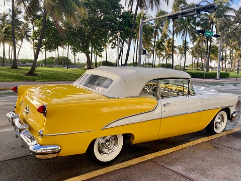 MIAMI, USA - AUG 18, 2014 : Cadillac Vintage car parked at Ocean Drive in Miami Beach, Florida. Art Deco architecture in South Beach is one of the main tourist attractions in Miami
