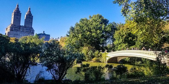 Bow Bridge and El Dorado building in Central Park in Manhattan, New York, USA.