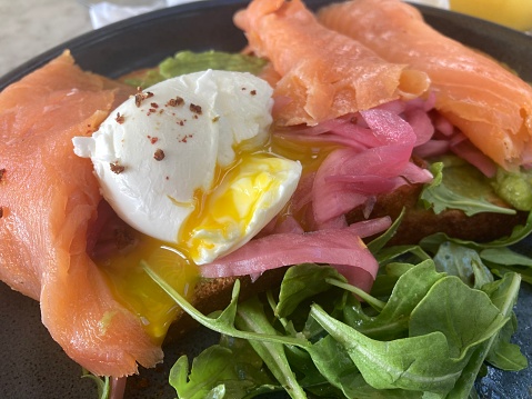 USA - food- avocado toast with egg, smoked salmon. Typical healthy American breakfast