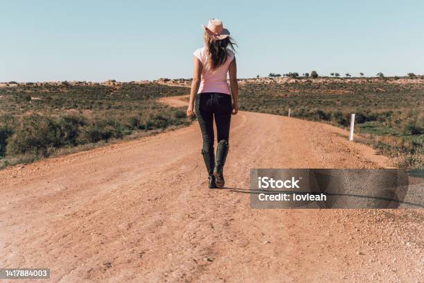 Woman Walking Dusty Roads Of Outback Australia Stock Photo - Download Image Now - 50-54 Years, Adult, Adults Only