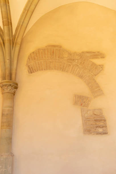 istock pillar against stucco wall in which masonry stones have been exposed 1417884103