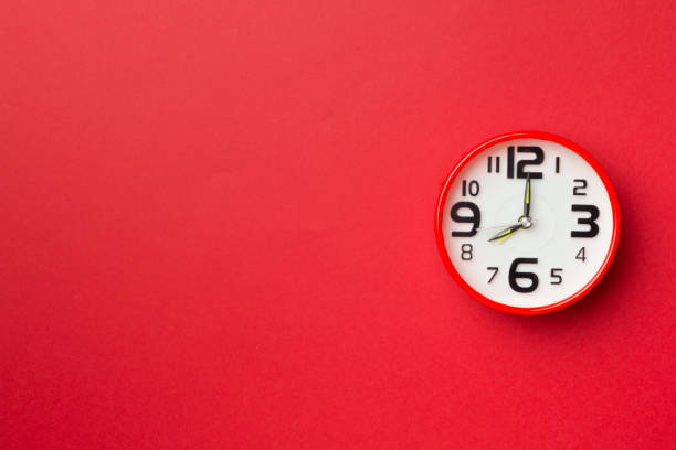 istock Red alarm clock on color background, top view 1417888851