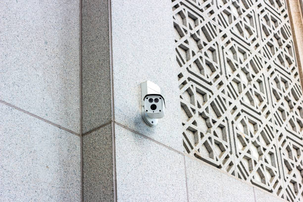 istock White CCTV security camera on the wall on the city street 1417888963