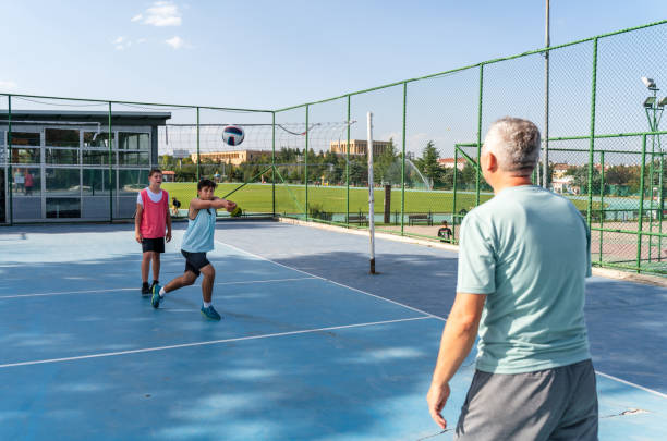 istock coach teaching his sons to play volleyball 1417889230