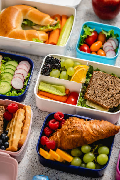 istock Shot of school lunchboxes with various healthy nutritious meals on stone background 1417890297