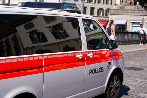 Police van of cantonal police force of Canton Zürich crossing Minster Bridge at the old town of Zürich on a sunny summer day. Photo taken July 2nd, 2022, Zurich, Switzerland.