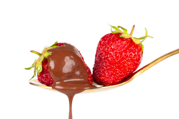 istock Strawberries on golden spoon with chocolate dipping isolated on white. Chocolate dripping from strawberries. Beautiful red berry. Sweet dessert. 1417891332