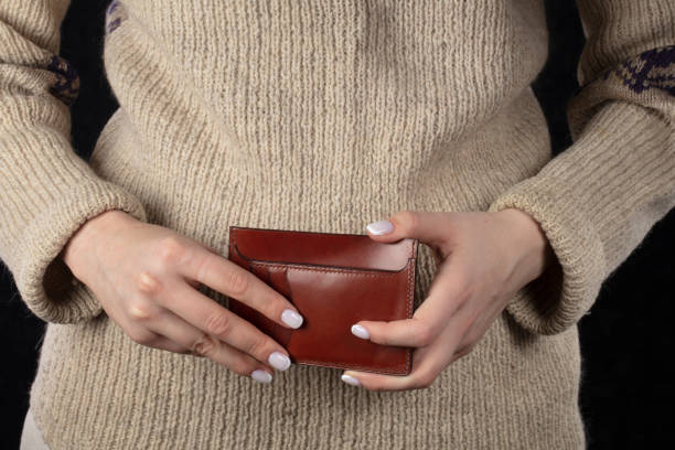 istock Leather wallet in female hands close-up. 1417892400