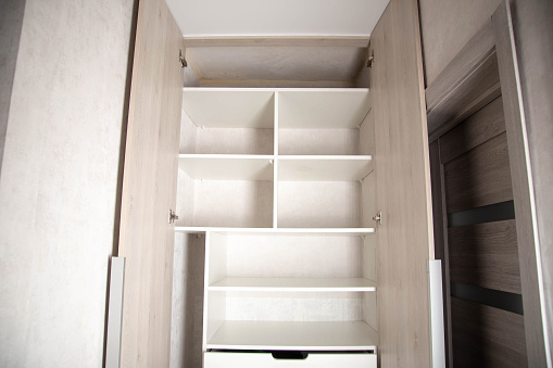 Modern closet in the hallway with hinged doors and pull-out shelves. Production of furniture under the order, organizer