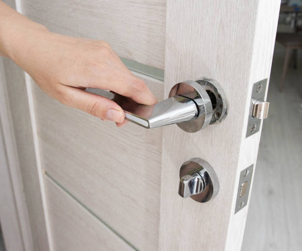 istock A man's hand opens an interior door with a broken doorknob. Poor quality door hardware, breakage, damage. 1417893721