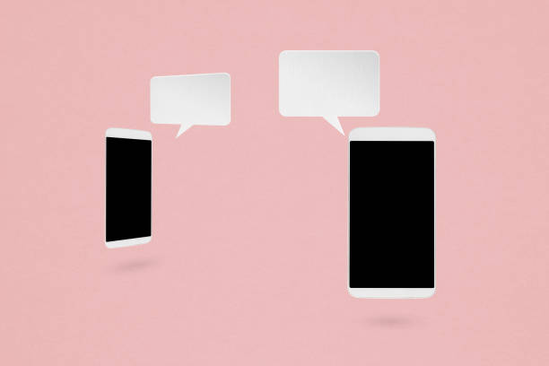istock two mobile phone and white blank speech bubble on grunge pink background. For business communication, technology, feedback, communication, QandA concept 1417895249