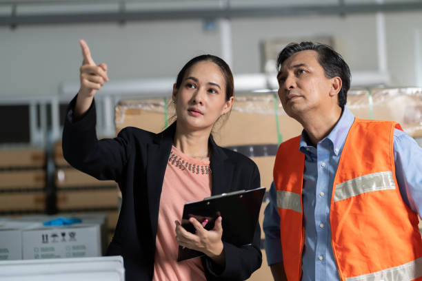 istock Man and woman worker working at warehouse. Inspection quality control 1417896933