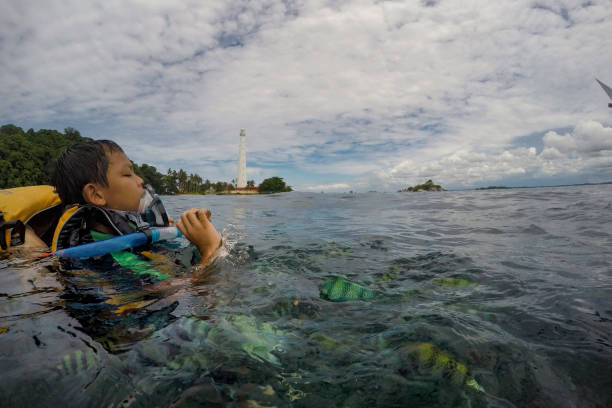 Tanjung Kelayang Photo is taken on December 13, 2016. Lengkuas Island is a small gem in Belitung, Indonesia, offers wonderful white sandy beach, turquoise blue waters and huge granite stones, not to mention the existence of a hundred years’ old Lighthouse. This is also a great snorkling spot  with beautiful coral and Indo-Pacific sergeant fish. abudefduf vaigiensis stock pictures, royalty-free photos & images